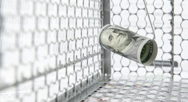 Rolled up dollar bill in a cage meant to conceptualize enticing money in illegal situations.